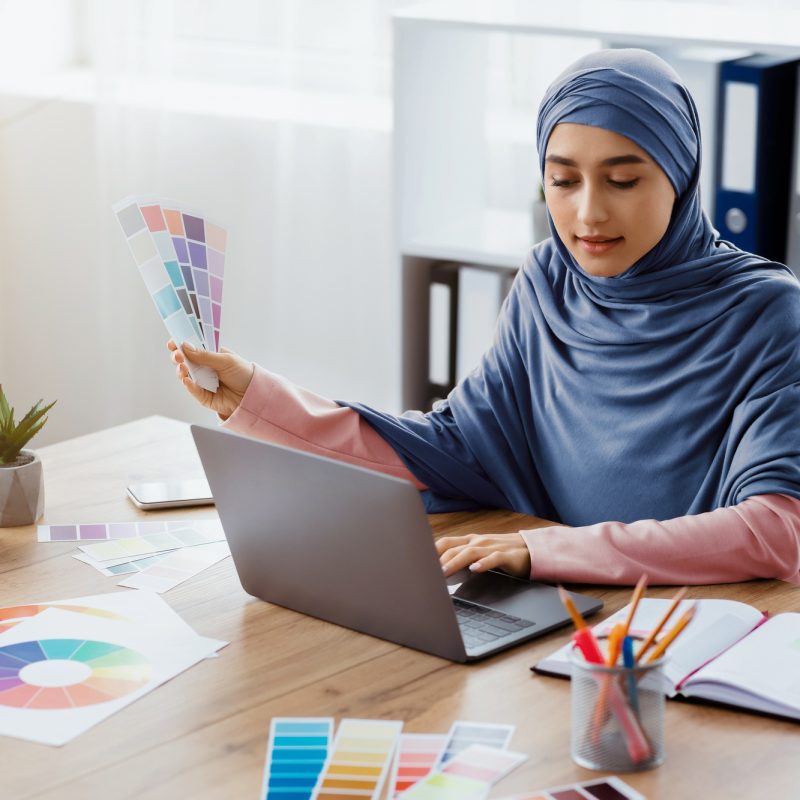 Arabic female graphic designer working on new project in office